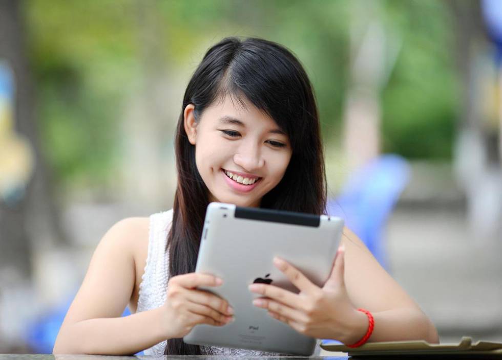 Girl using an old iPad