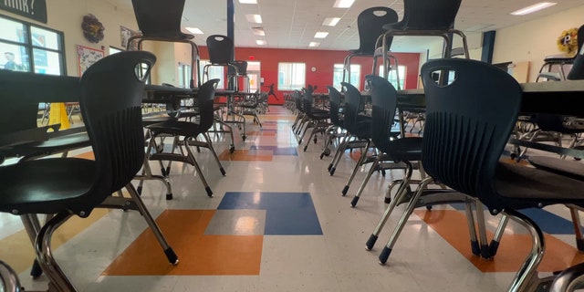 A school classroom with desks and chairs