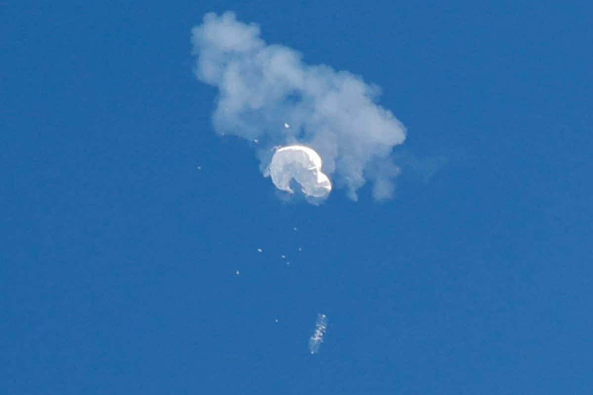 A Chinese spy balloon drifting to the ocean after being shot down