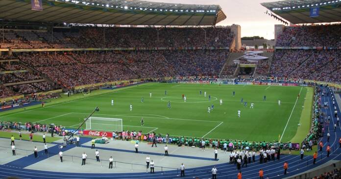 massive open air soccer stadium with a game in play.jpg