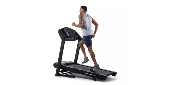 The Horizon Fitness T101 GO Series Treadmill on a white background with someone running on it.